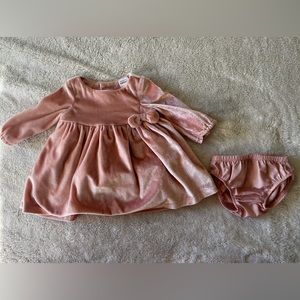 Newborn baby dress.  100% polyester under layer and 100% nylon lining.